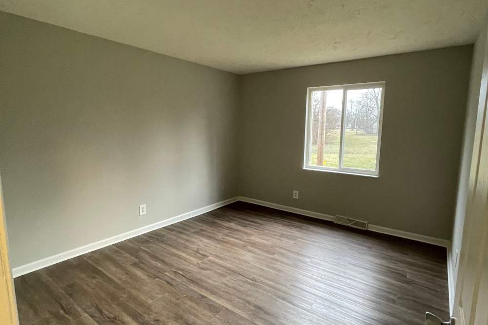 Modern bedroom with large window at Cumberland Manor in Indianapolis, Indiana