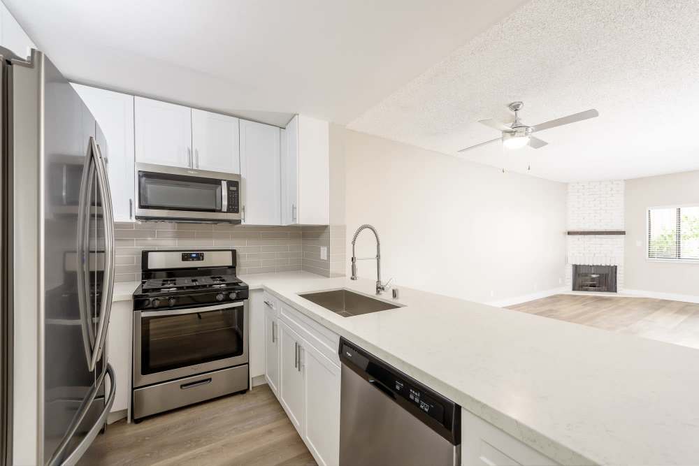  Kitchen with modern cabinetry and solid quartz countertops with appliances at The Indie Glendale Collection in Glendale, California