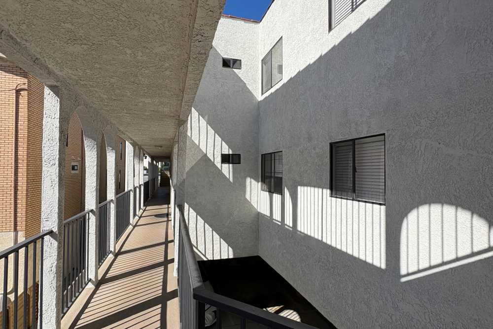Outdoor walkway of an apartment building black railings at The Indie Glendale Collection in Glendale, California