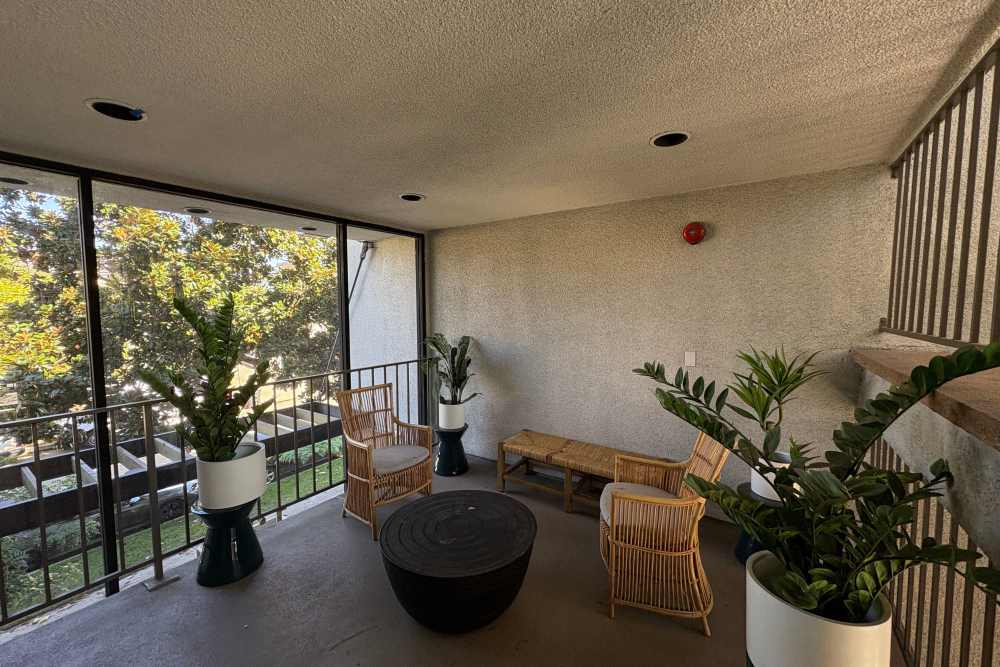 Cane seating and plants in balcony at The Indie Glendale Collection in Glendale, California