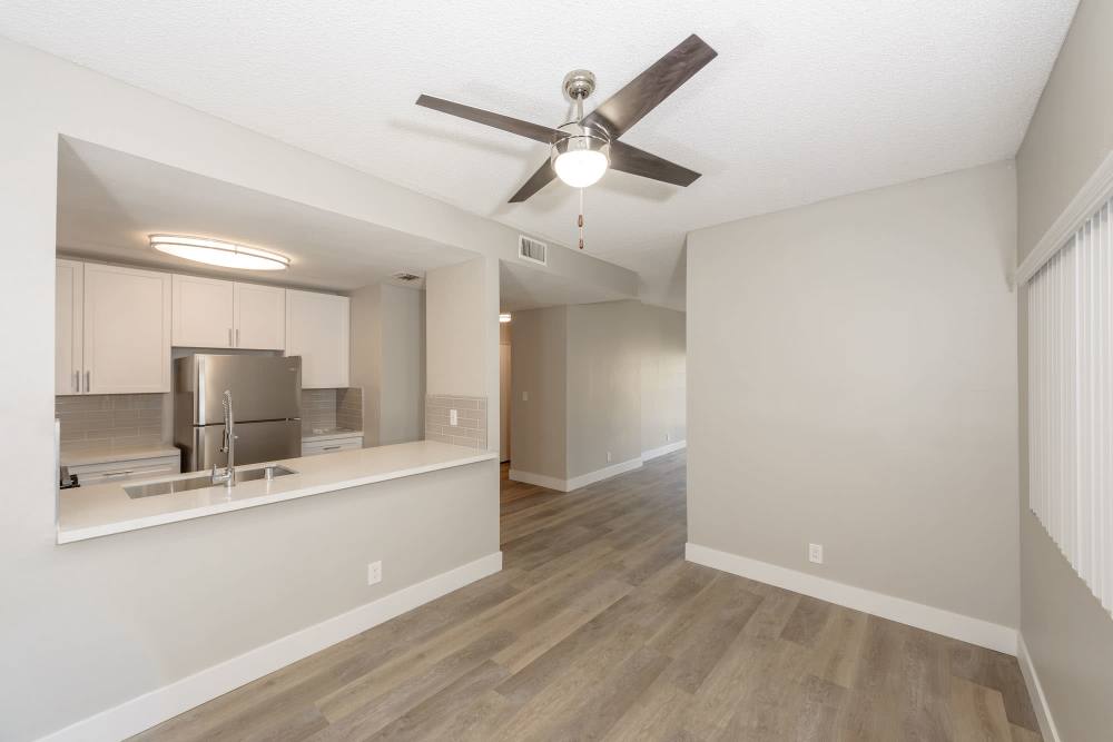 Dining room with Hardwood-style flooring, close access to fully-equipped kitchen with passthrough island at The Indie Glendale Collection in Glendale, California
