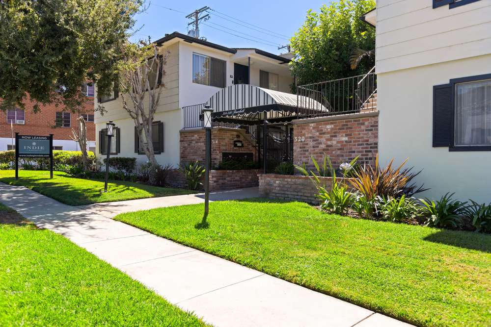 Outer left view of community with walkway and lawn at The Indie Glendale Collection in Glendale, California