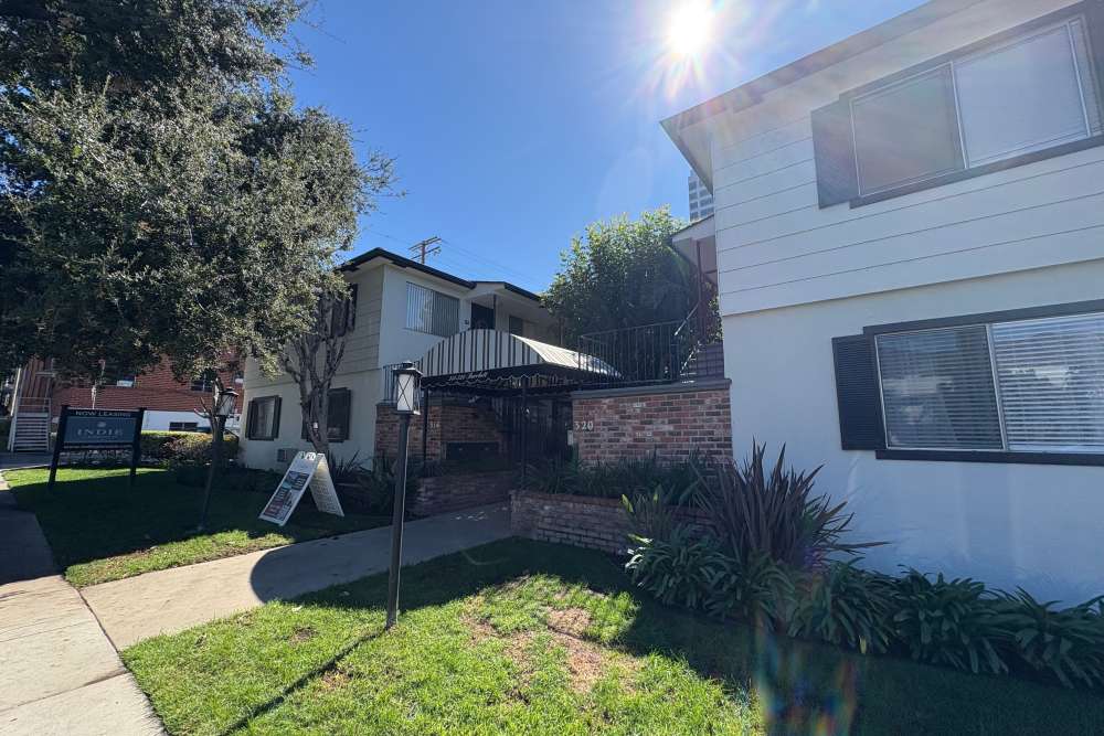 Inside community view showing walkway, trees and houses at The Indie Glendale Collection in Glendale, California