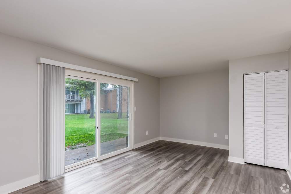 vacant living area with hardwood style flooring at Harborstone in Newport News, Virginia