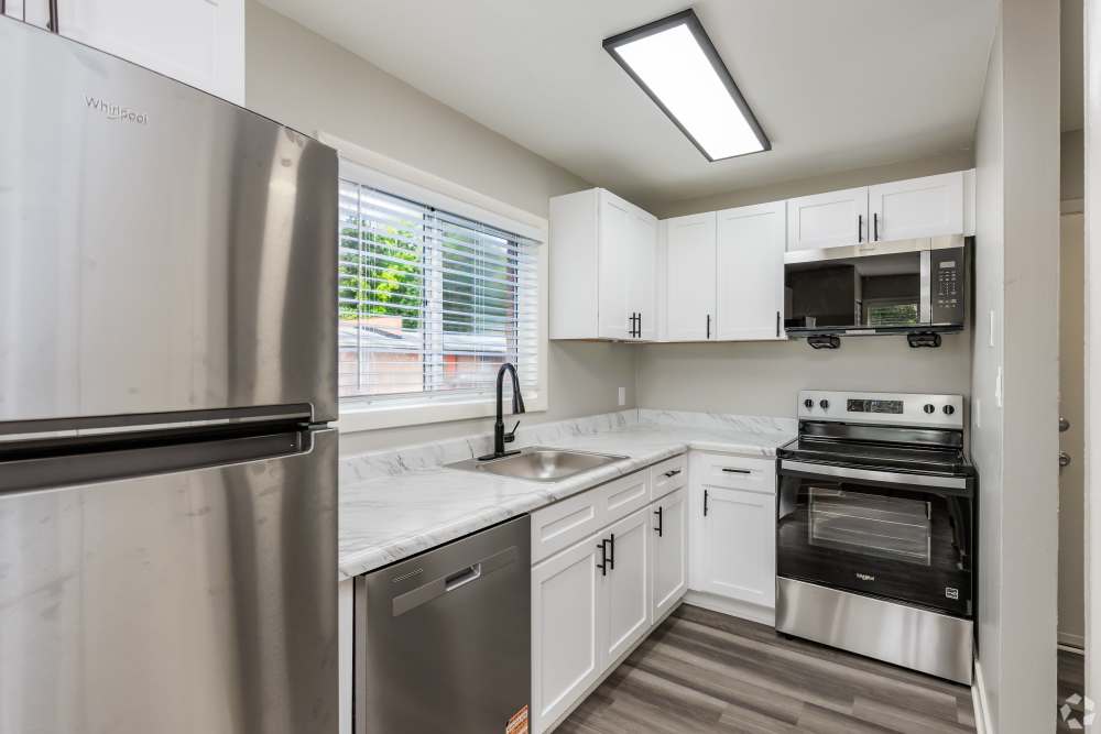 renovated kitchen with white cabinets and stainless appliances at Harborstone in Newport News, Virginia