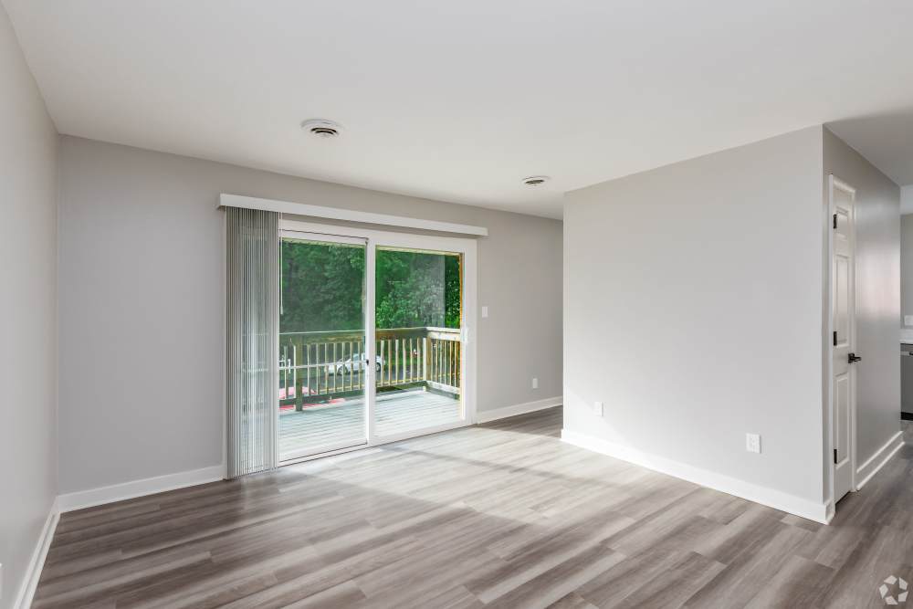 vacant living area with hardwood style flooring at Harborstone in Newport News, Virginia