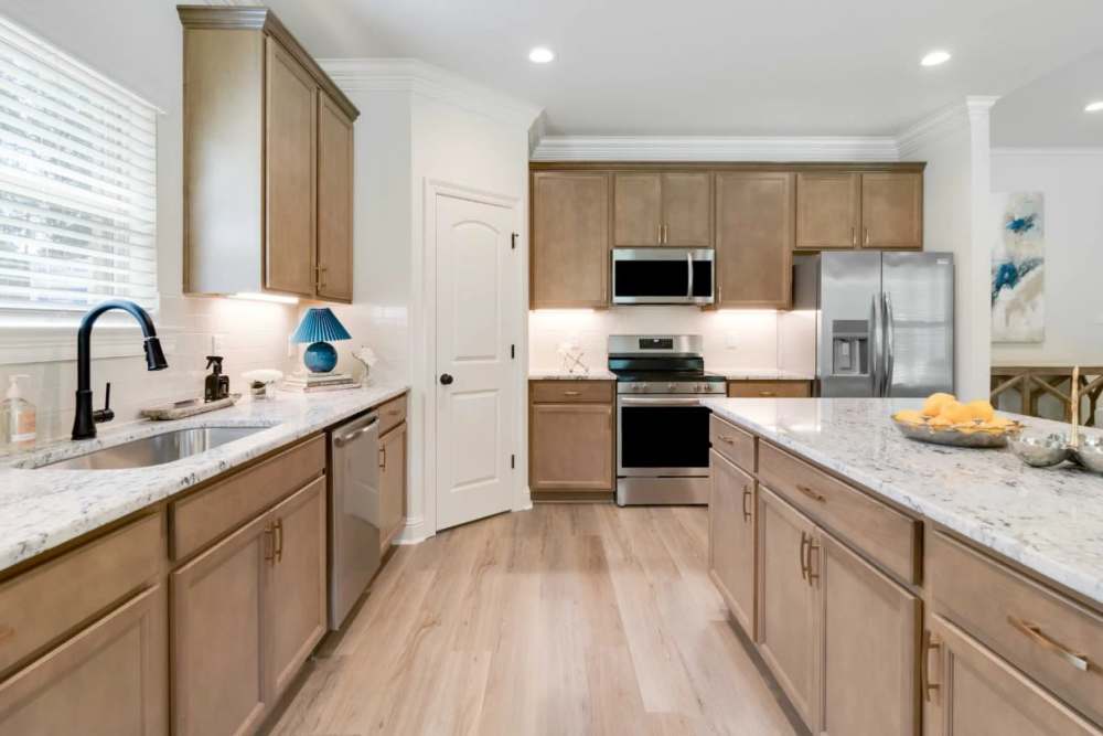 Spacious kitchen with wood-style flooring at Willow Brook Townhomes in Bossier City, Louisiana 