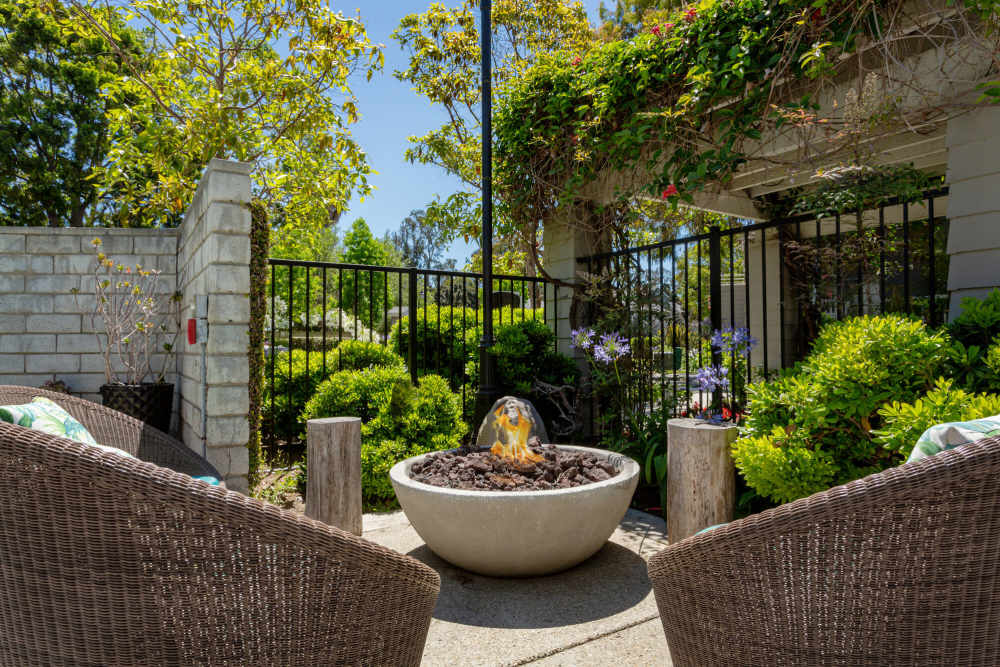 Charming outdoor space with fire pit and lush greenery at Colony Parc in Ventura, California