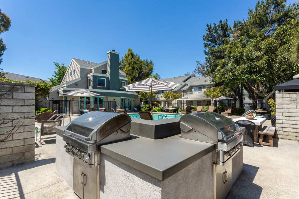 Stylish outdoor grilling area by the sparkling pool at Colony Parc in Ventura, California