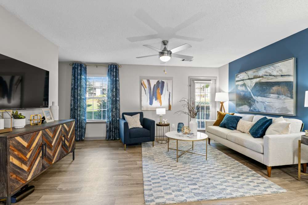 Modern living room with blue accent wall at Ascent Apartment Homes in Asheville, North Carolina