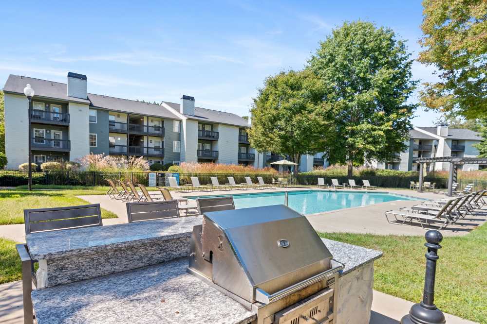 Apartment pool with outdoor grilling station at Ascent Apartment Homes in Asheville, North Carolina