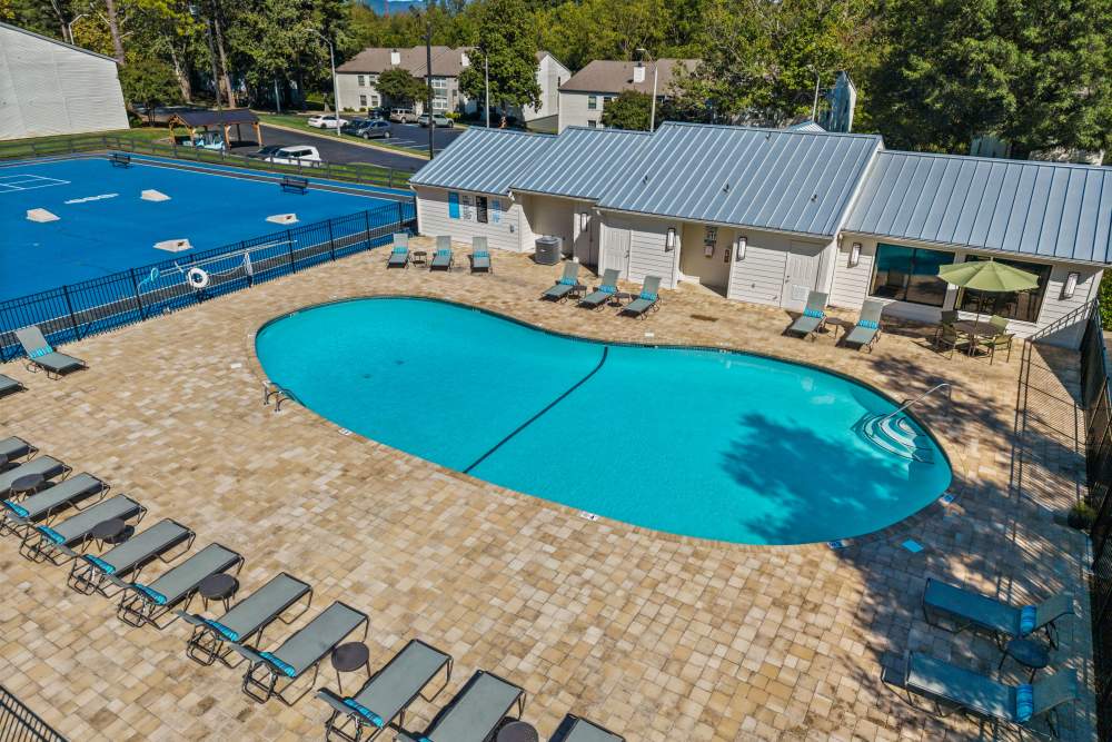 Outdoor swimming pool with lounge seating at Ascent Apartment Homes in Asheville, North Carolina