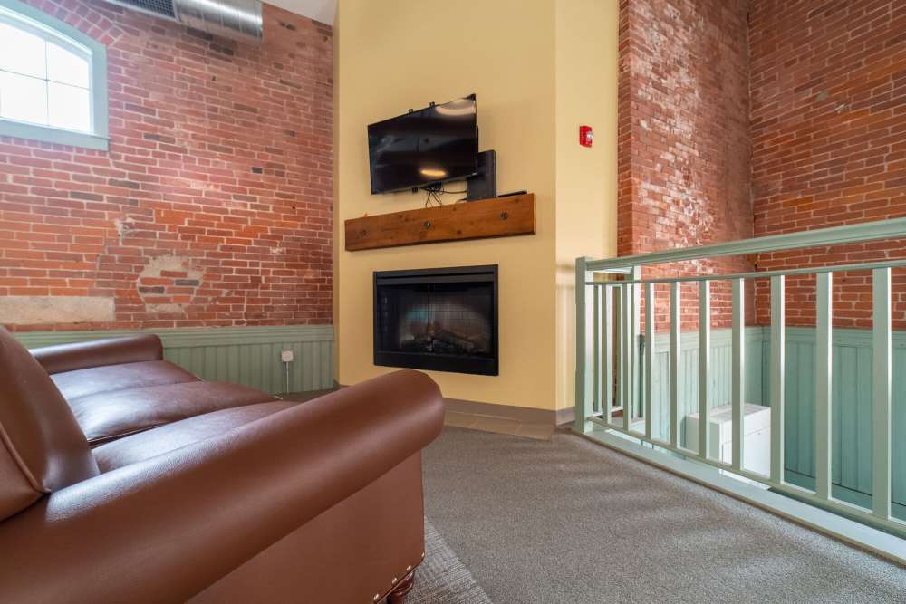 Indoor seating with television at Linwood Mill Apartments in Whitinsville, Massachusetts