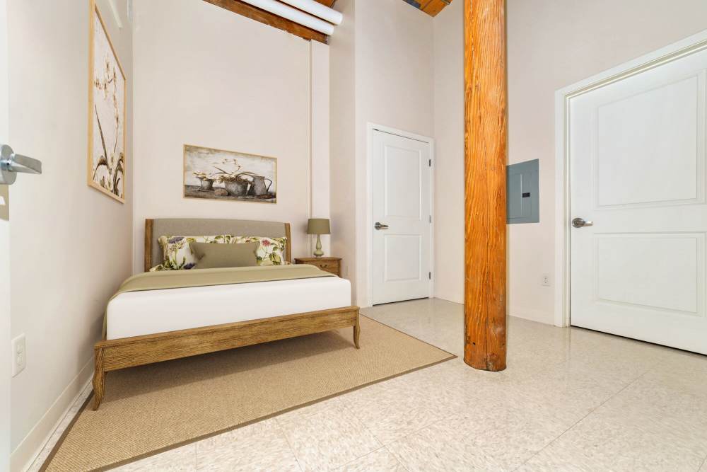Bedroom with a comfortable bed at Linwood Mill Apartments in Whitinsville, Massachusetts