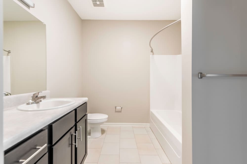 Bathroom with frameless vanity mirror at Jefferson Green in Louisville, Kentucky