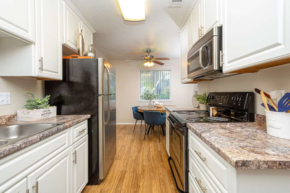 Kitchen with black and steel color appliance  at Willow Grove in Modesto, California