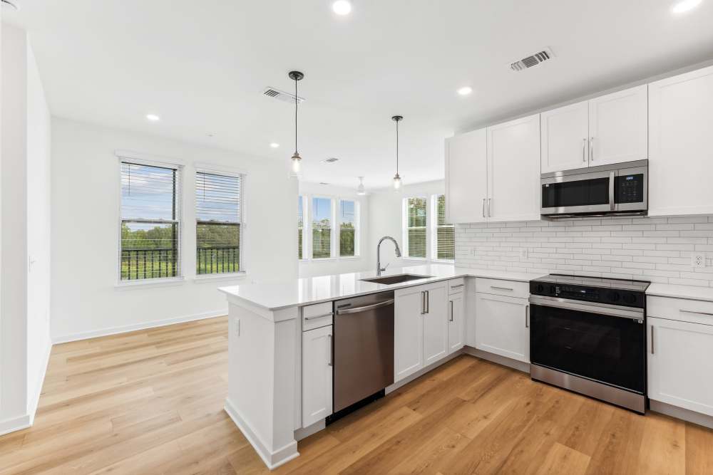 Apartment kitchen with white storage at Mosby Barclay West in Wilmington, North Carolina