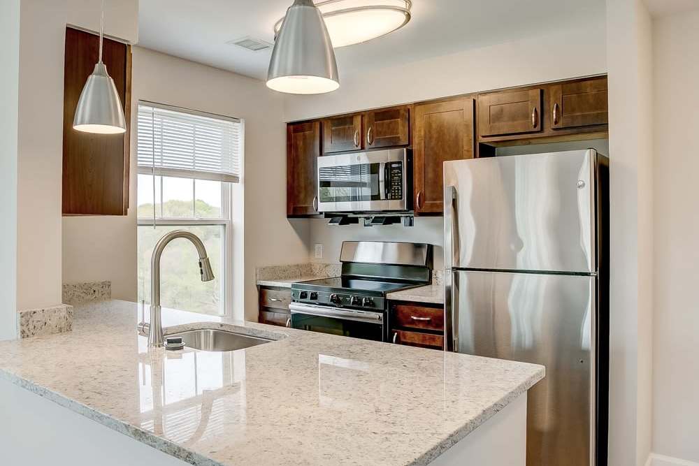 Apartment kitchen with stainless-steel appliances at Snowden Creek in Eldersburg, Maryland