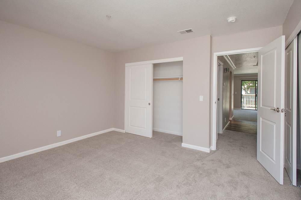 Bedroom with carpet flooring at Sandpiper Village Apartment Homes in Vacaville,California