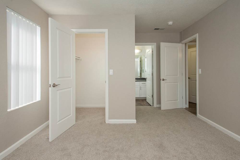 Bedroom with walk-in closet and attached bathroom at Sandpiper Village Apartment Homes in Vacaville,California