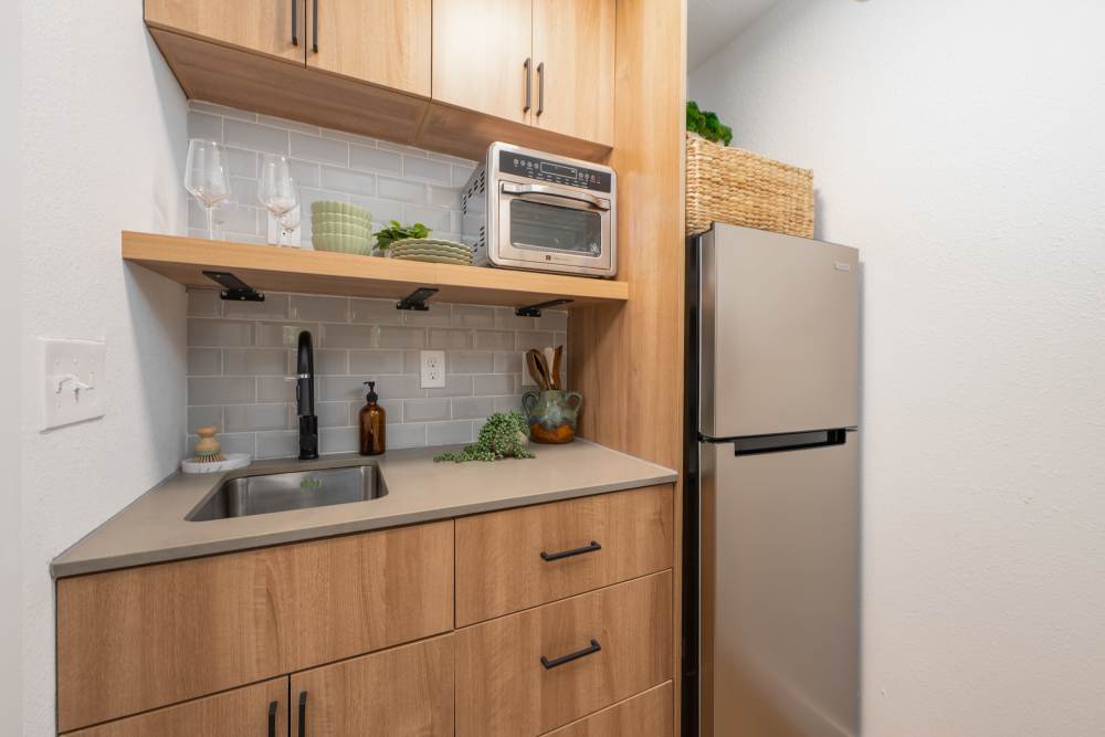 Modern kitchen with wooden cabinets at Bellevue Ridge Apartments in Bellevue, Washington  