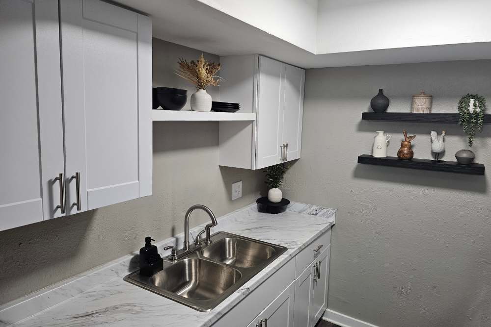 Fully equipped kitchen with dark wood style cabinetry at Castle Hill in Sherman, Texas