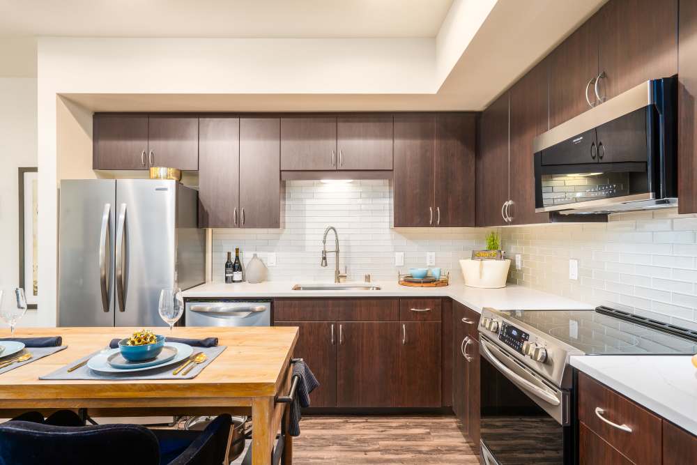 Kitchen with wooden cabinetry at LINQ Midtown in Sacramento,California