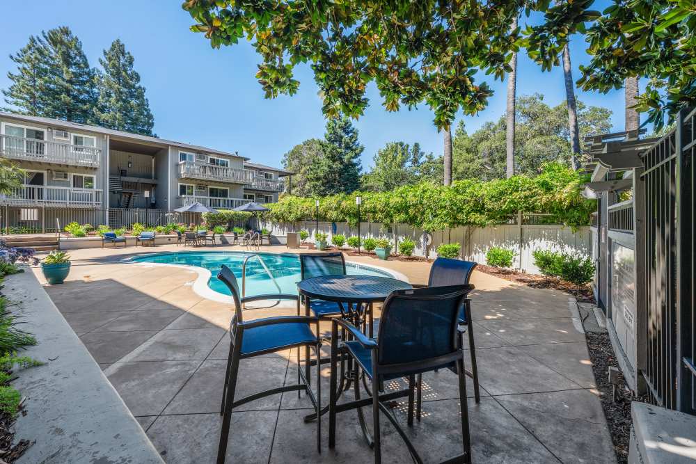 Seating by the pool side at Regency Plaza Apartment Homes in Martinez, California