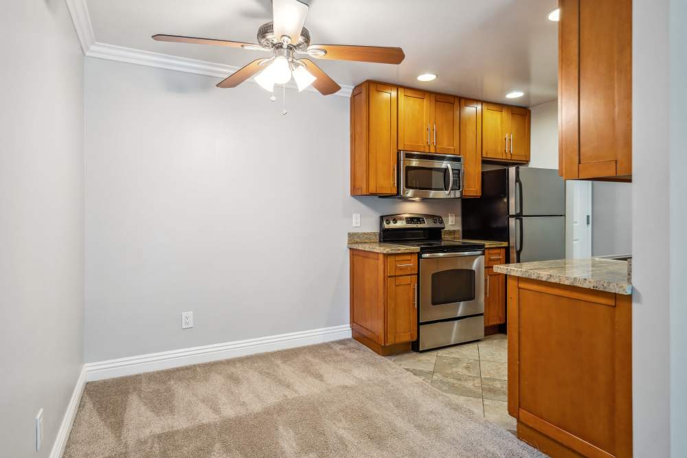 Apartment kitchen with a ceiling fan at Regency Plaza Apartment Homes in Martinez, California