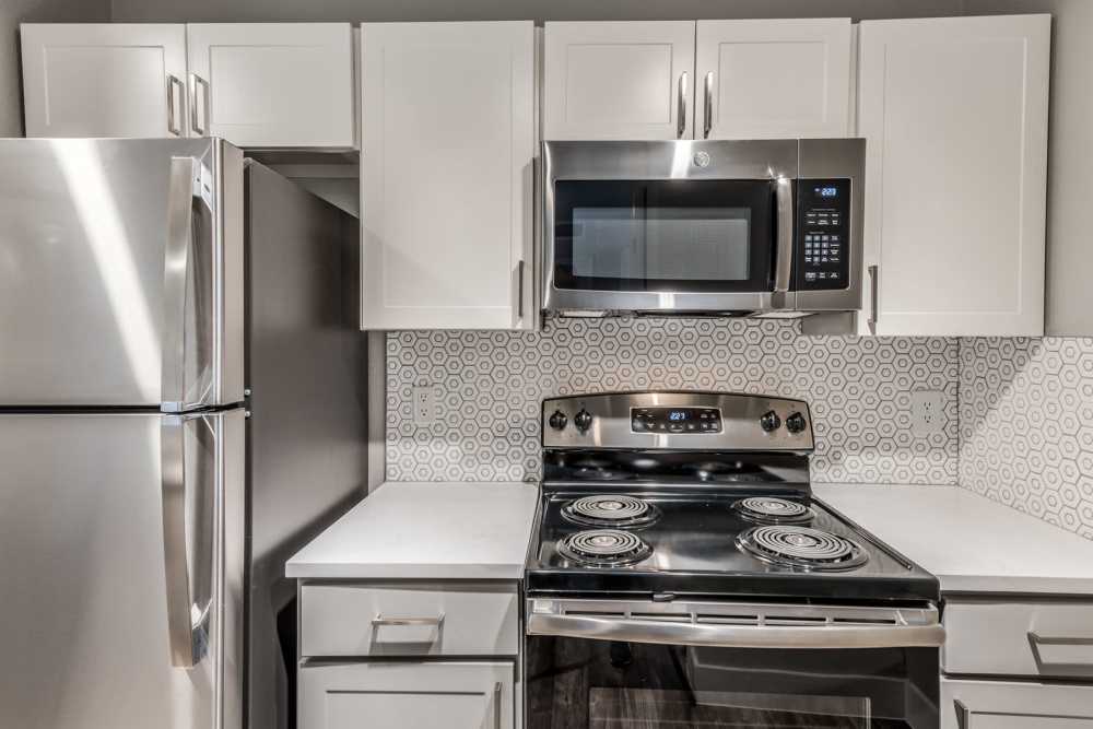 Kitchen with stainless-steel appliances at Warwick at Westchase in Houston, Texas