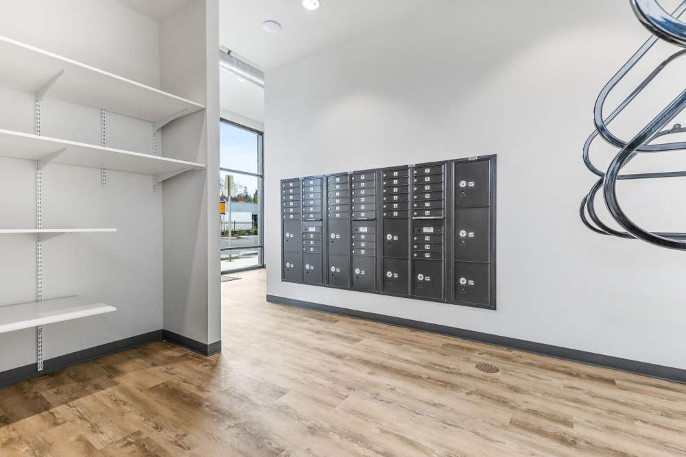 Mailroom with shelves and secure mailboxes at Cartwright Apartments in Salem, Oregon.