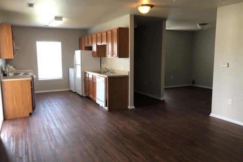 Kitchen with wood-style flooring at The Meadows in Lake Charles, Louisiana