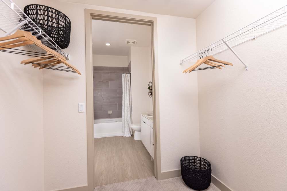 View of closet and connecting bathroom at Zeta Luxury Apartments in Sacramento, California