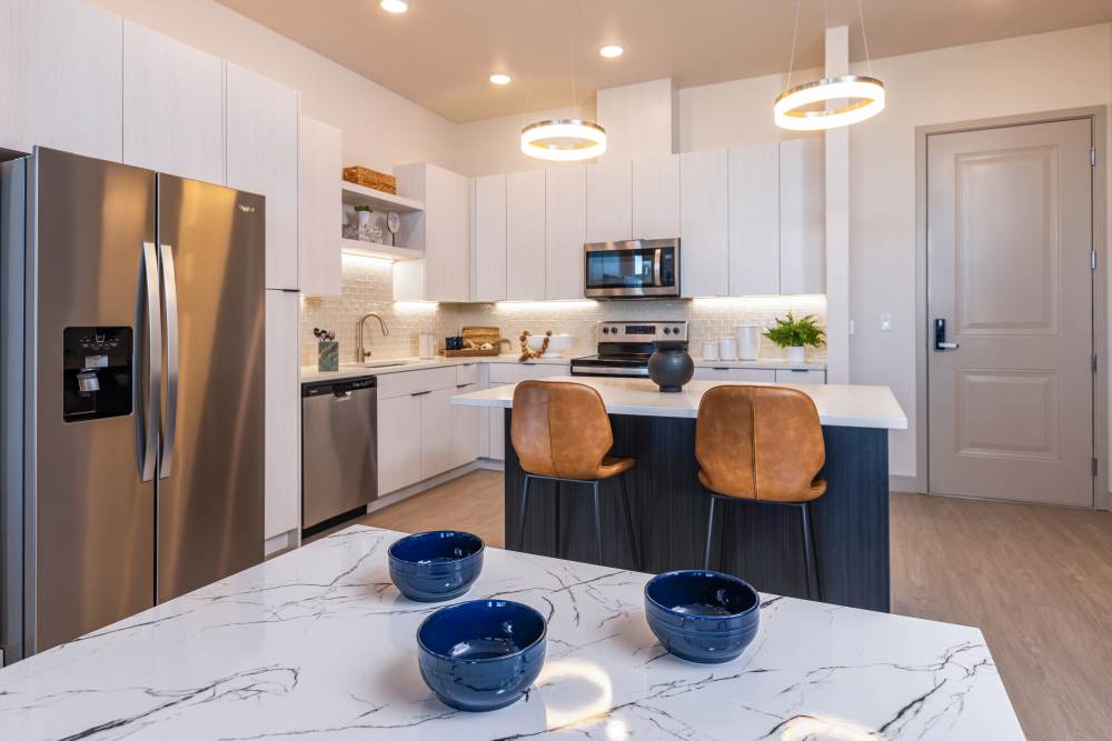 Dining room with close access to fully-equipped kitchen with oven and stove at Zeta Luxury Apartments in Sacramento, California