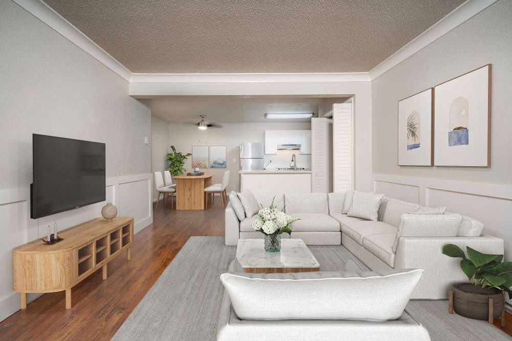 Spacious living room with sectional sofa and TV at Breakwater Apartments in Santa Cruz, California