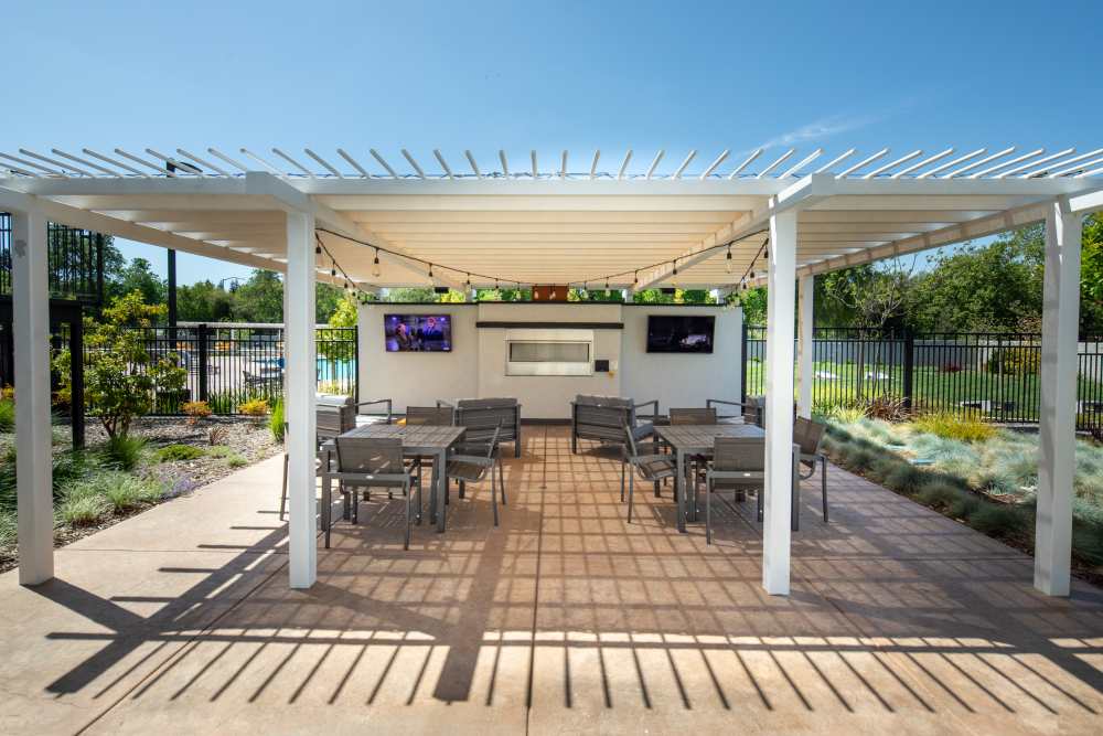 Outdoor canopy with fireplace and seating at Solasta in Sacramento, California
