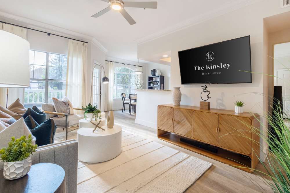 Well-lit living room with ceiling fan at The Kinsley at Perimeter Center in Atlanta, Georgia