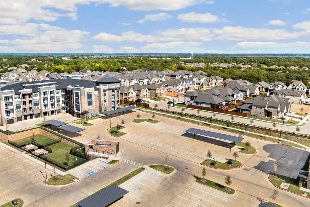 Aerial view of apartment buildings and surrounding neighborhood at The Heyward Apartments in Corinth, Texas.