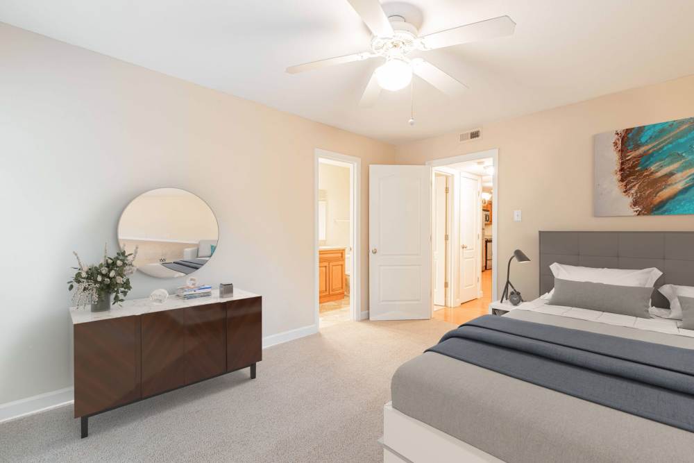 Bedroom with a comfortable bed at Peachtree Apartments in Chesterfield, Missouri