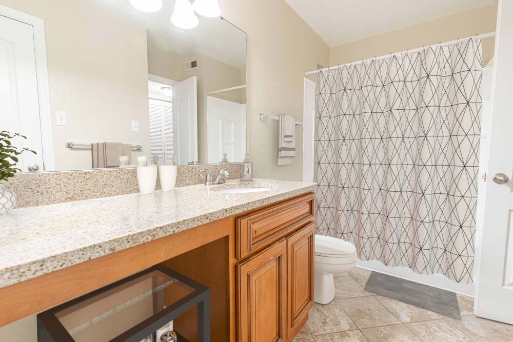 Bathroom with a mirror at Peachtree Apartments in Chesterfield, Missouri