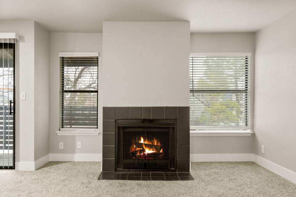 Fireplace in living room between two windows at Waterside in Tulsa, Oklahoma