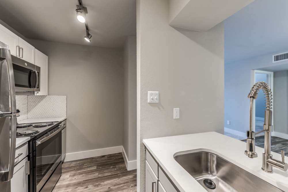 Kitchen with island sink at at Warwick at Westchase in Houston, Texas