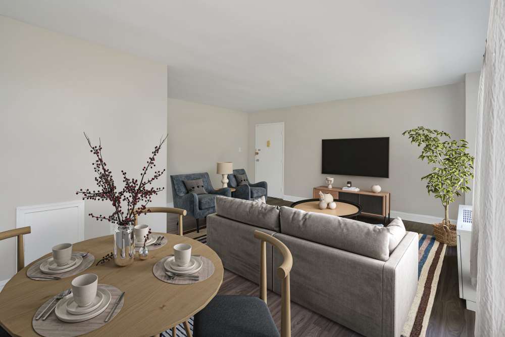 Living room with table at Braddock Lee Apartments in Alexandria, Virginia  