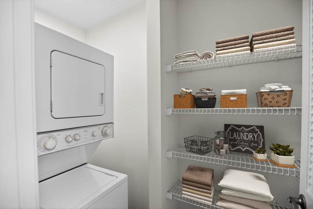 Eagle Rock Apartments at Columbia Pike in-unit washer and dryer with laundry storage in Arlington, Virginia.