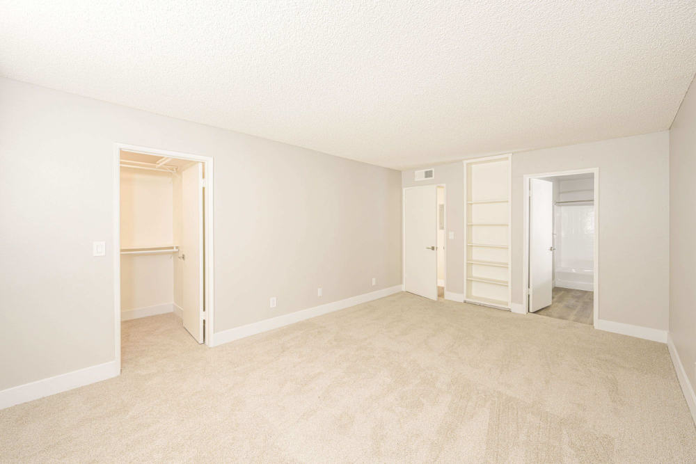 Large bedroom with walk-in closet and built-in shelves at The Indie Glendale Collection in Glendale, California