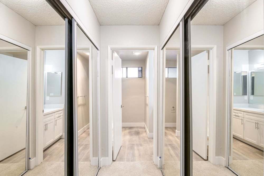 Spacious hallway with mirrored closet doors and vanity area at The Indie Glendale Collection in Glendale, California