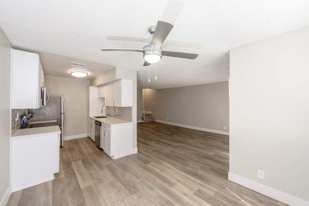 Spacious kitchen and living area with ceiling fan at The Indie Glendale Collection in Glendale, California
