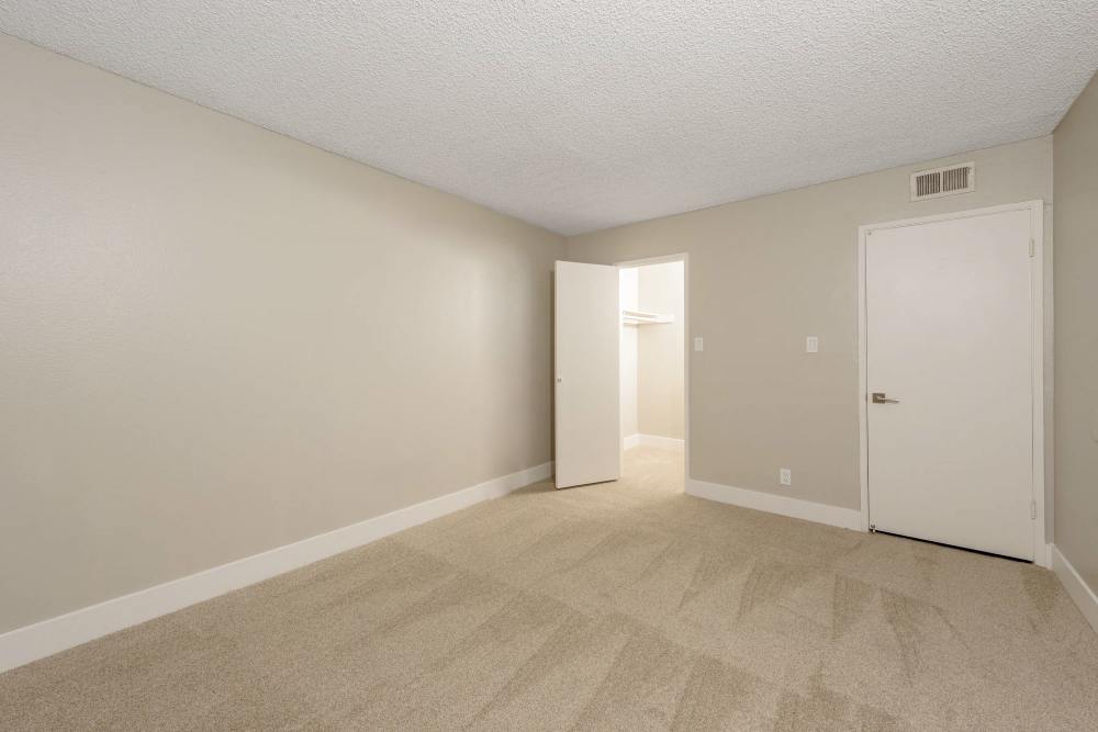 Bedroom with open closet and door at The Indie Glendale Collection in Glendale, California
