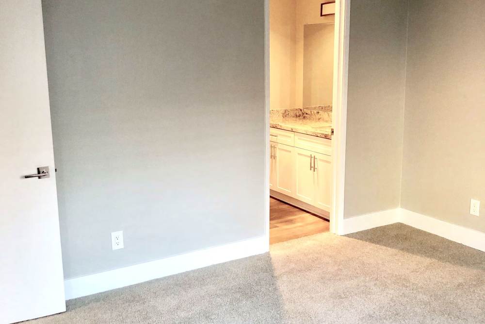 Bedroom with doorway to bathroom at The Indie Glendale Collection in Glendale, California
