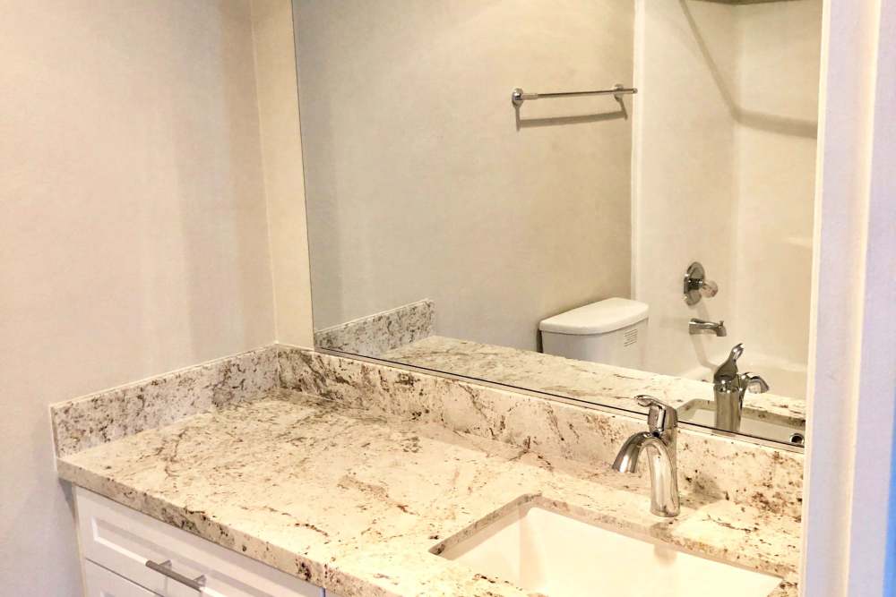 Bathroom vanity with granite countertop at The Indie Glendale Collection in Glendale, California